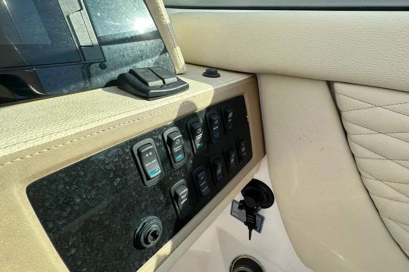 Slide: The Image of Control panel of a 2019 Regal 26 OBX boat with beige interior. - 38