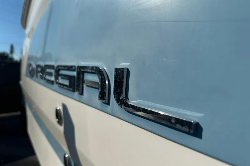 Slide: The Image of 2019 Regal 26 OBX boat logo on a blue and white hull. - 4