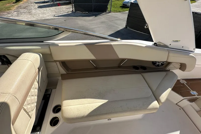 Slide: The Image of 2019 Regal 26 OBX boat interior with beige seating and cup holders. - 42