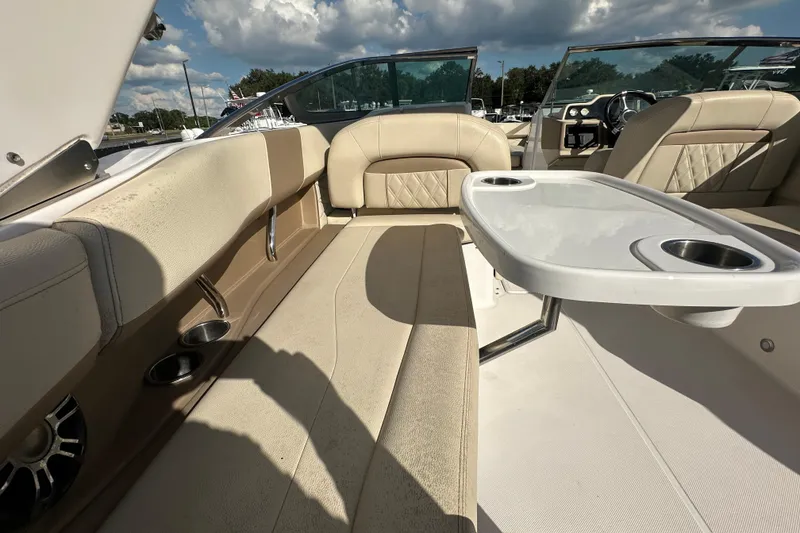 Slide: The Image of 2019 Regal 26 OBX boat interior with beige seating and a white table. - 51