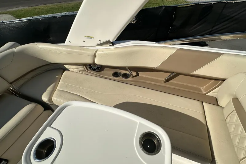 Slide: The Image of 2019 Regal 26 OBX boat interior with beige seating and cup holders. - 52