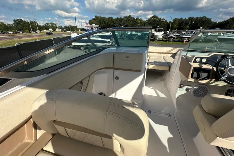 Slide: The Image of 2019 Regal 26 OBX boat interior with beige seating and modern dashboard. - 54