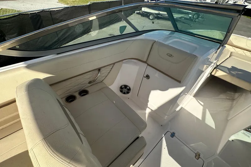 Slide: The Image of 2019 Regal 26 OBX boat interior with beige seating and cup holders. - 55