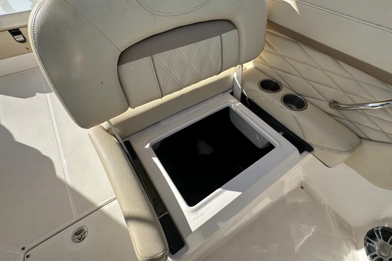 Slide: The Image of 2019 Regal 26 OBX boat seat with storage compartment and cup holders. - 57