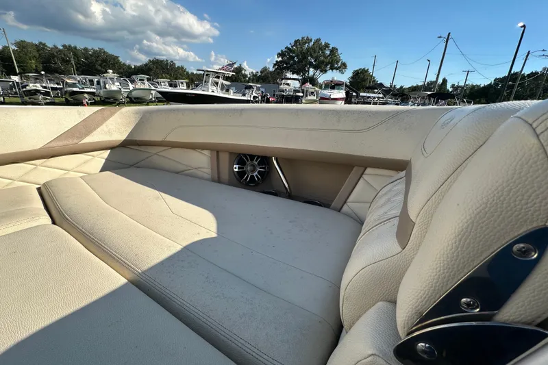 Slide: The Image of Luxurious interior of a 2019 Regal 26 OBX boat with plush seating and speaker. - 71