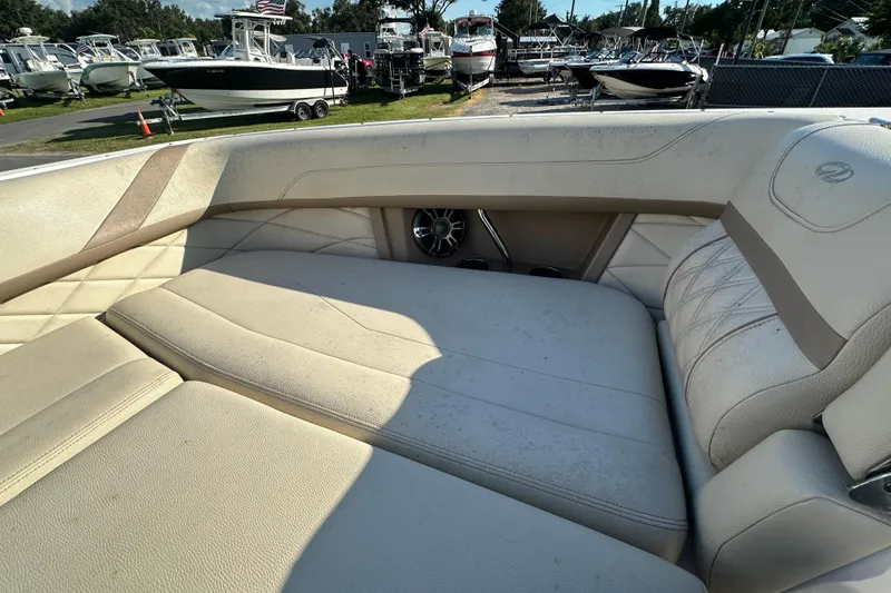 Slide: The Image of 2019 Regal 26 OBX boat interior with beige seating and speaker detail. - 72