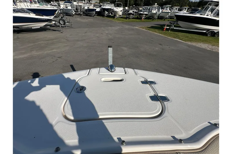Slide: The Image of 2019 Regal 26 OBX boat deck in a marina with multiple boats. - 74