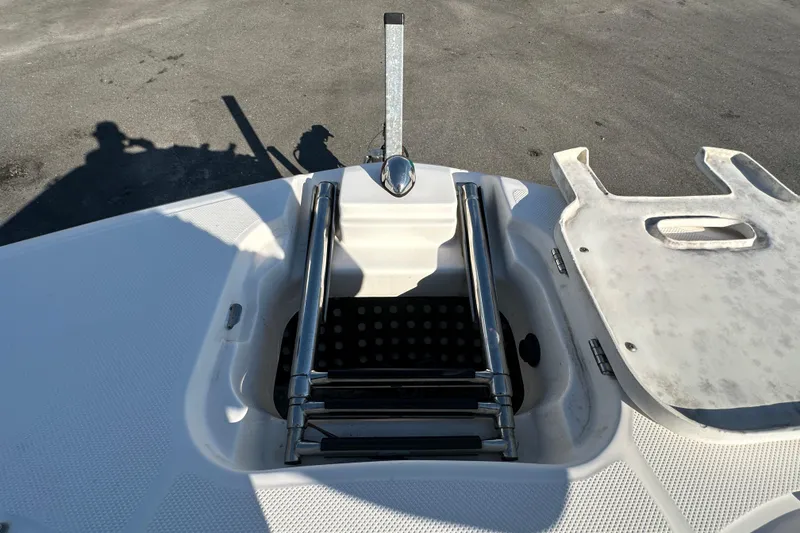 Slide: The Image of 2019 Regal 26 OBX boat with a folded stainless steel swim ladder on deck. - 75