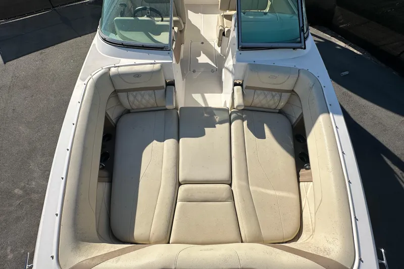 Slide: The Image of 2019 Regal 26 OBX boat with spacious beige seating and windshield. - 78