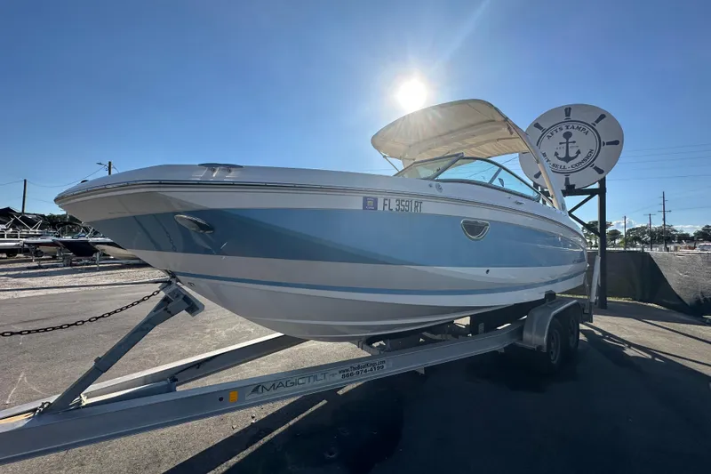Slide: The Image of 2019 Regal 26 OBX boat on trailer under sunny sky at Tampa dealership. - 8