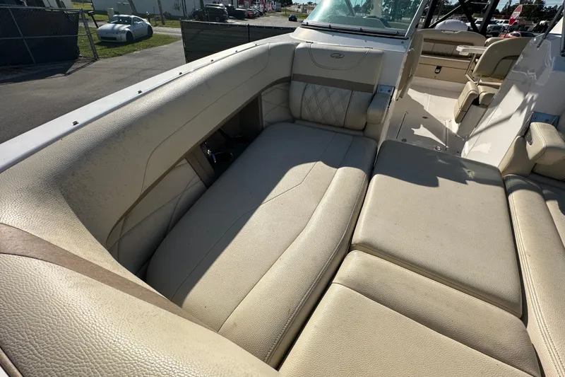 Slide: The Image of 2019 Regal 26 OBX boat interior with beige leather seating and spacious layout. - 80