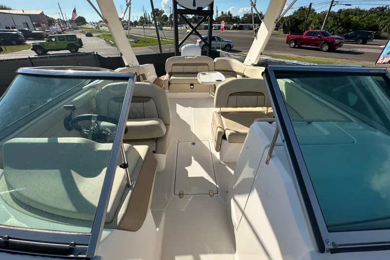 Slide: The Image of 2019 Regal 26 OBX boat interior with beige seating and open deck layout. - 83