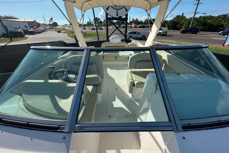 Slide: The Image of 2019 Regal 26 OBX boat interior with seating and steering wheel, viewed from the bow. - 84