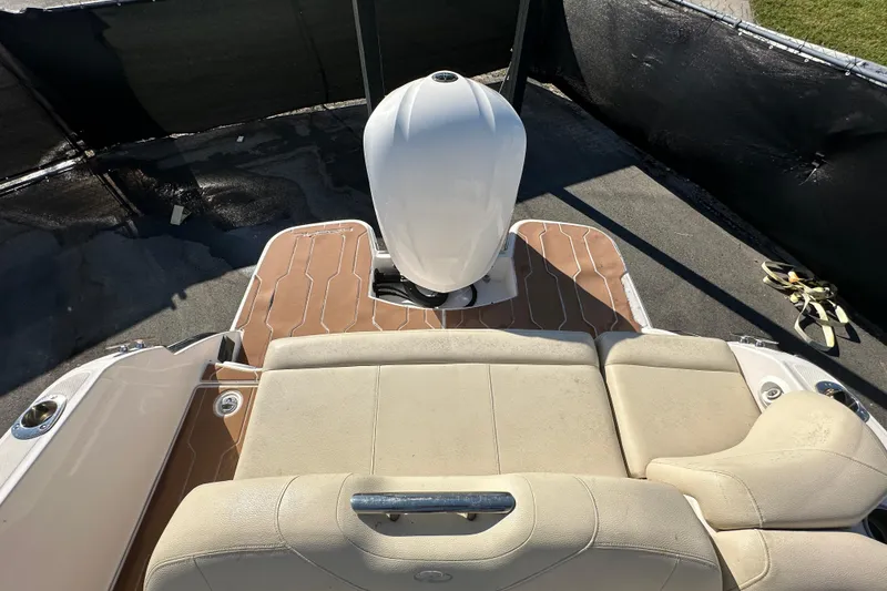 Slide: The Image of 2019 Regal 26 OBX boat interior with beige seating and outboard motor. - 87