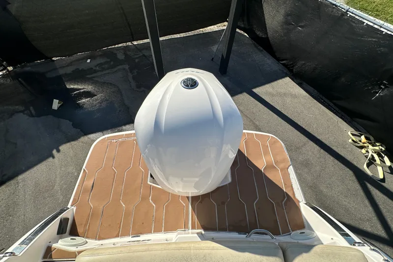 Slide: The Image of 2019 Regal 26 OBX boat with outboard motor on wooden deck. - 88