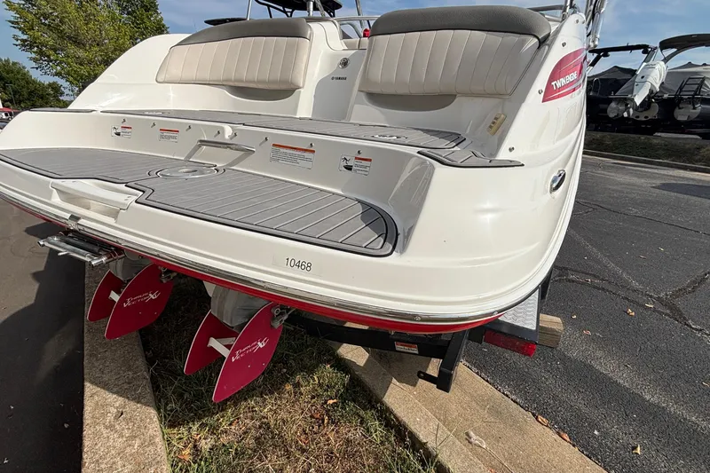 Slide: The Image of 2008 Yamaha Boats SX230 in red and white on a trailer, parked outdoors. - 3