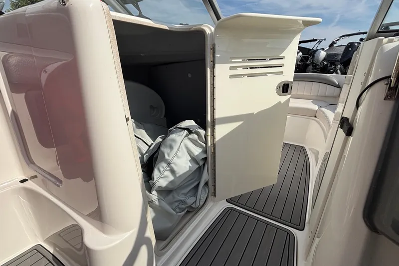 Slide: The Image of 2008 Yamaha Boats SX230 with red cover on trailer, parked outdoors. - 8