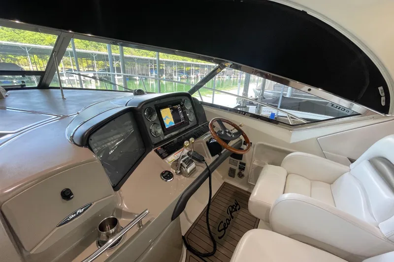 Slide: The Image of 2007 Sea Ray 38 Sundancer helm with modern controls and comfortable seating. - 11