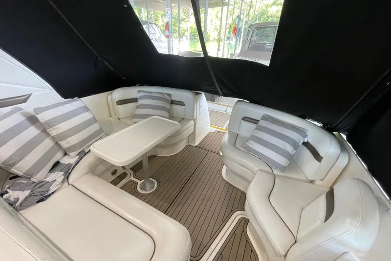 Slide: The Image of Luxurious 2007 Sea Ray 38 Sundancer interior with white seating and striped cushions. - 12