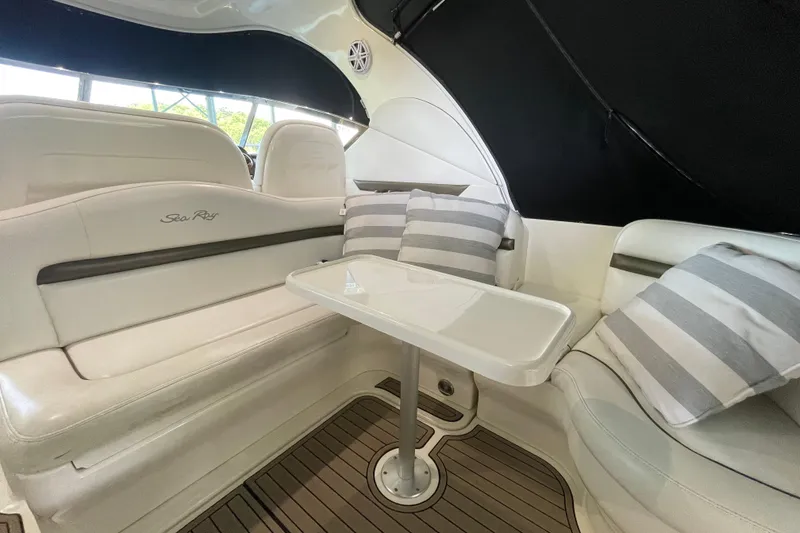 Slide: The Image of Interior of 2007 Sea Ray 38 Sundancer with seating and striped cushions. - 16