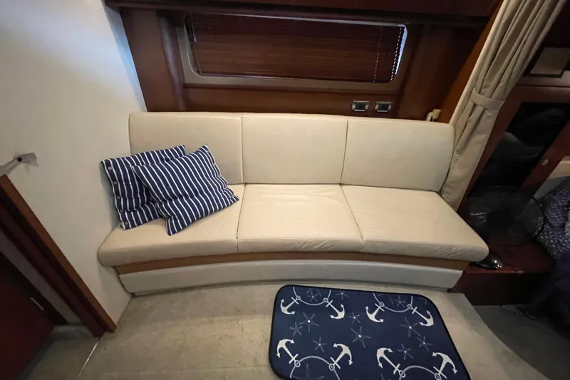 Slide: The Image of Interior of 2007 Sea Ray 38 Sundancer with beige sofa and nautical-themed decor. - 17