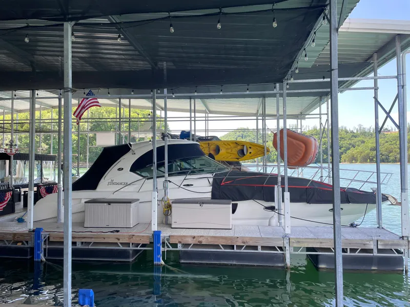 Slide: The Image of 2007 Sea Ray 38 Sundancer docked with kayaks on top. - 2