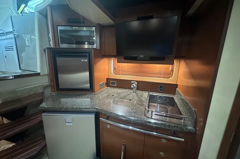 Slide: The Image of 2007 Sea Ray 38 Sundancer yacht kitchen with modern appliances and sleek design. - 20