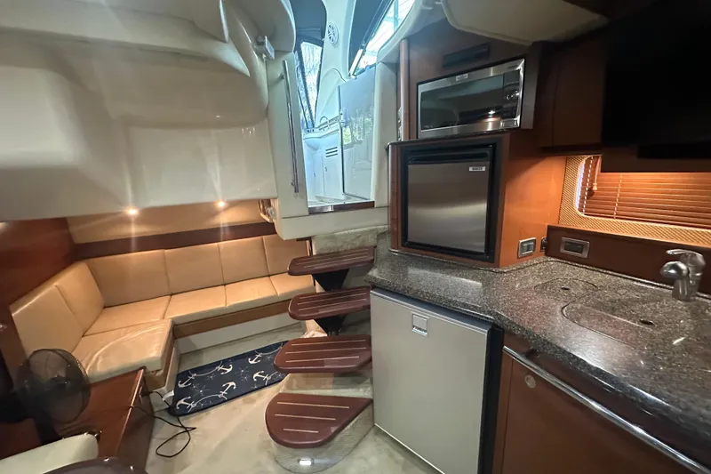 Slide: The Image of Luxurious 2007 Sea Ray 38 Sundancer yacht interior with kitchenette and seating area. - 21