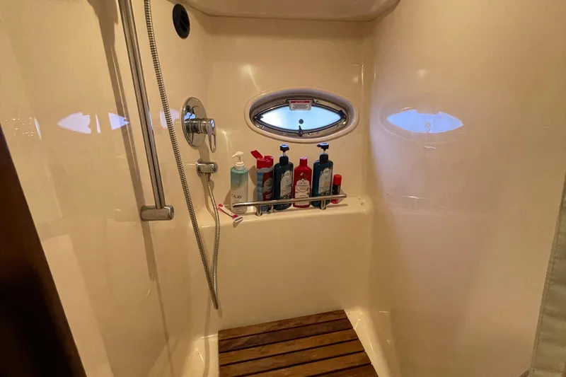 Slide: The Image of Shower area in 2007 Sea Ray 38 Sundancer yacht with toiletries and porthole window. - 25