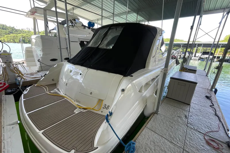 Slide: The Image of 2007 Sea Ray 38 Sundancer docked under a covered marina, rear view. - 27