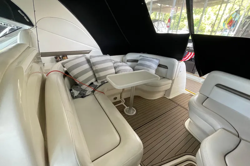Slide: The Image of Luxurious 2007 Sea Ray 38 Sundancer interior with plush seating and striped cushions. - 8