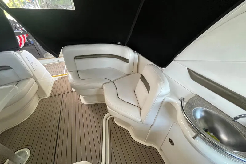 Slide: The Image of 2007 Sea Ray 38 Sundancer interior with white seating and compact sink. - 9