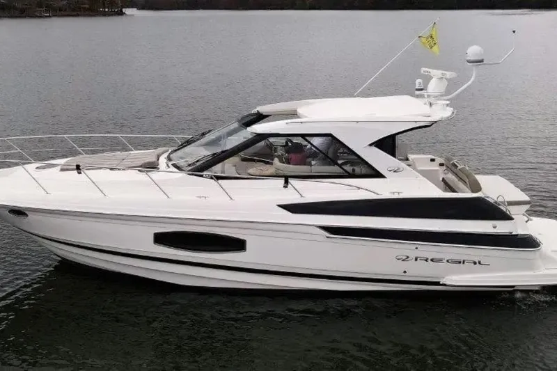 The Image of 2016 Regal 46 Sport Coupe yacht on calm water, side view. - 0