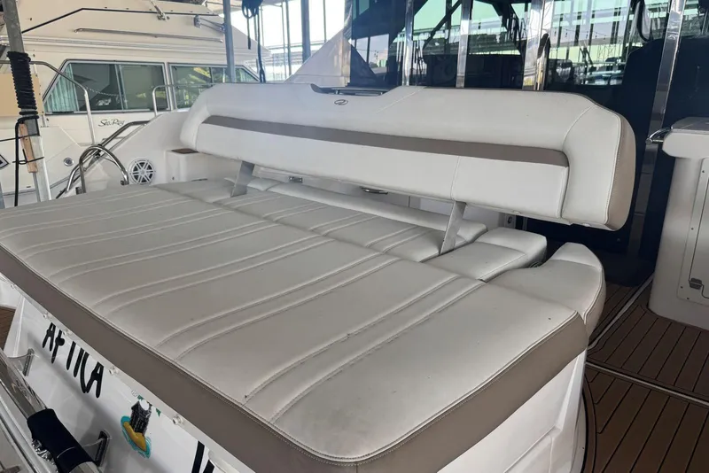 Slide: The Image of 2016 Regal 46 Sport Coupe yacht with white cushioned seating area. - 12