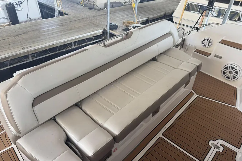 Slide: The Image of Luxurious seating on 2016 Regal 46 Sport Coupe yacht, featuring elegant beige upholstery. - 13