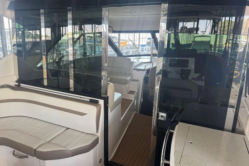 Slide: The Image of Interior view of 2016 Regal 46 Sport Coupe yacht with seating and glass doors. - 16