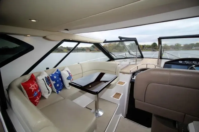 Slide: The Image of Interior of 2016 Regal 46 Sport Coupe yacht with seating and decorative pillows. - 18