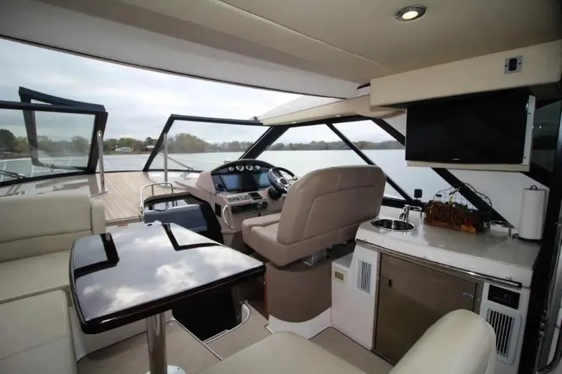 Slide: The Image of Luxurious interior of 2016 Regal 46 Sport Coupe yacht with helm, seating, and kitchenette. - 21