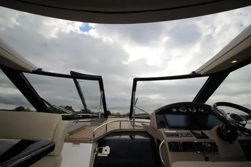 Slide: The Image of 2016 Regal 46 Sport Coupe yacht interior with open sunroof and modern dashboard controls. - 22