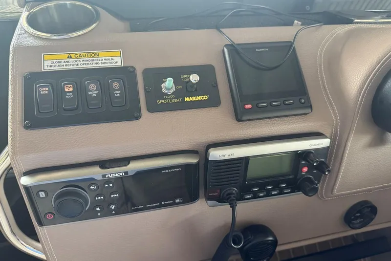 Slide: The Image of Control panel of a 2016 Regal 46 Sport Coupe with various navigation and communication devices. - 29