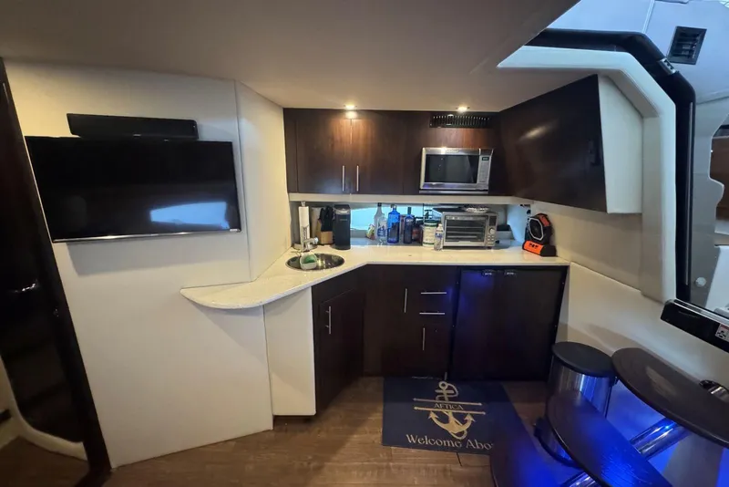 Slide: The Image of Interior of 2016 Regal 46 Sport Coupe yacht with kitchenette and modern amenities. - 32