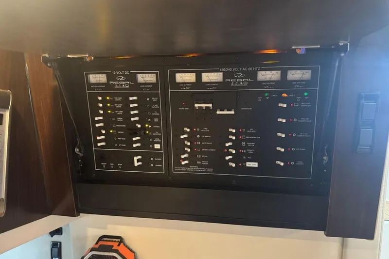 Slide: The Image of Control panel of a 2016 Regal 46 Sport Coupe yacht, featuring various switches and indicators. - 34