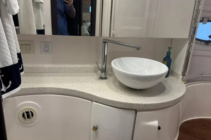 Slide: The Image of Modern bathroom vanity in 2016 Regal 46 Sport Coupe yacht, featuring vessel sink and sleek faucet. - 36