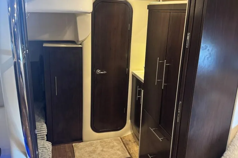 Slide: The Image of Interior of 2016 Regal 46 Sport Coupe with dark wood cabinetry and door. - 39