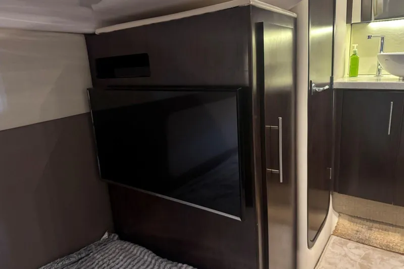 Slide: The Image of Interior of 2016 Regal 46 Sport Coupe featuring a mounted TV and modern cabinetry. - 41