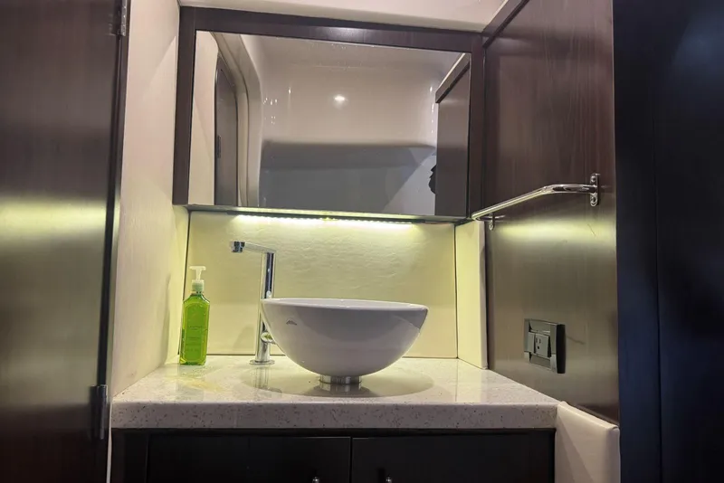 Slide: The Image of Modern bathroom vanity in 2016 Regal 46 Sport Coupe yacht, featuring vessel sink and mirror. - 42