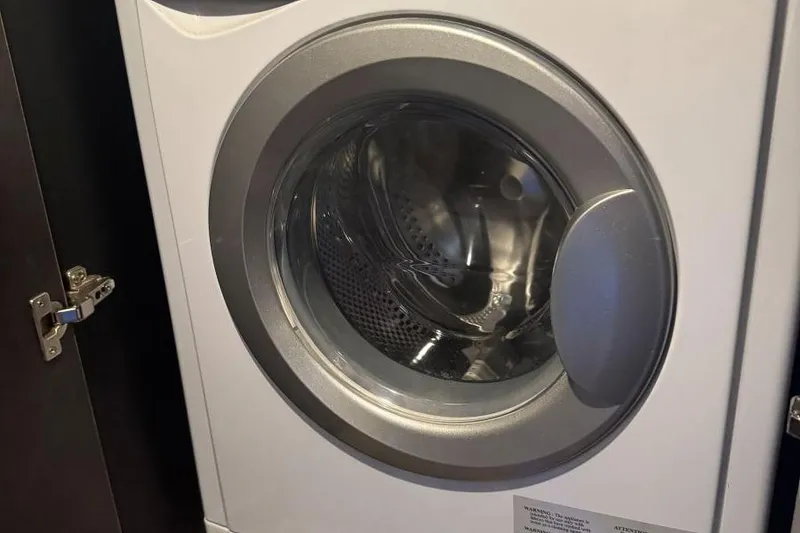 Slide: The Image of Front-loading washing machine in a compact space, partially open cabinet door. - 45