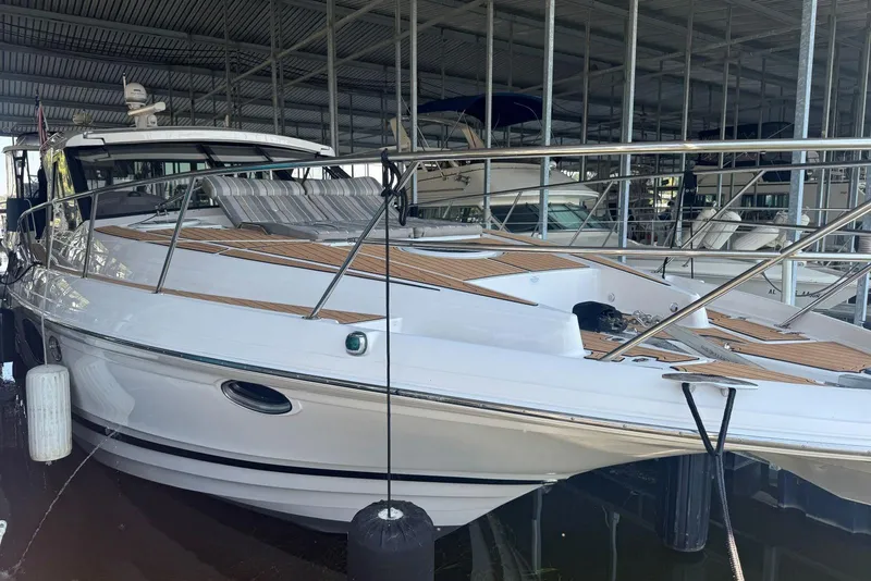 Slide: The Image of 2016 Regal 46 Sport Coupe yacht docked in a marina, showcasing sleek design and luxury features. - 7