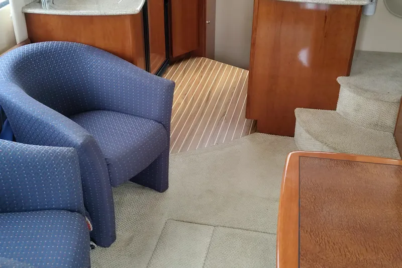 Slide: The Image of Interior of a 2007 Meridian 341 Sedan yacht with blue chairs and wooden accents. - 6