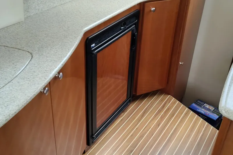 Slide: The Image of 2007 Meridian 341 Sedan interior with wood cabinetry and compact refrigerator. - 7